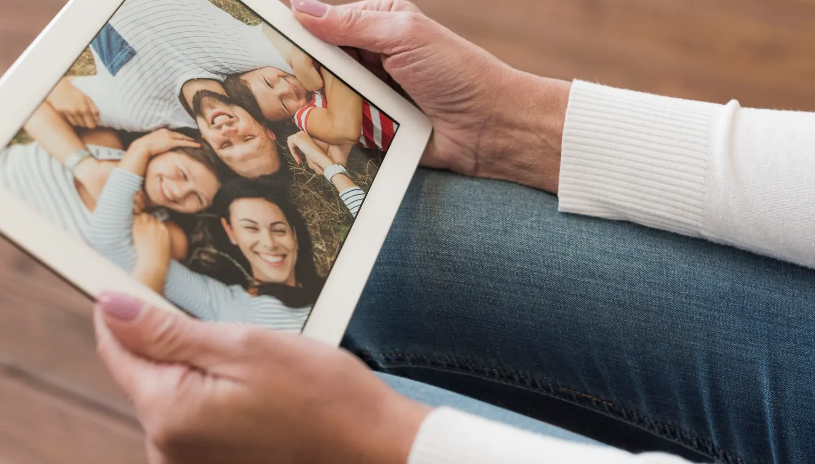 Hands holding a family portrait, representing the legacy we leave behind